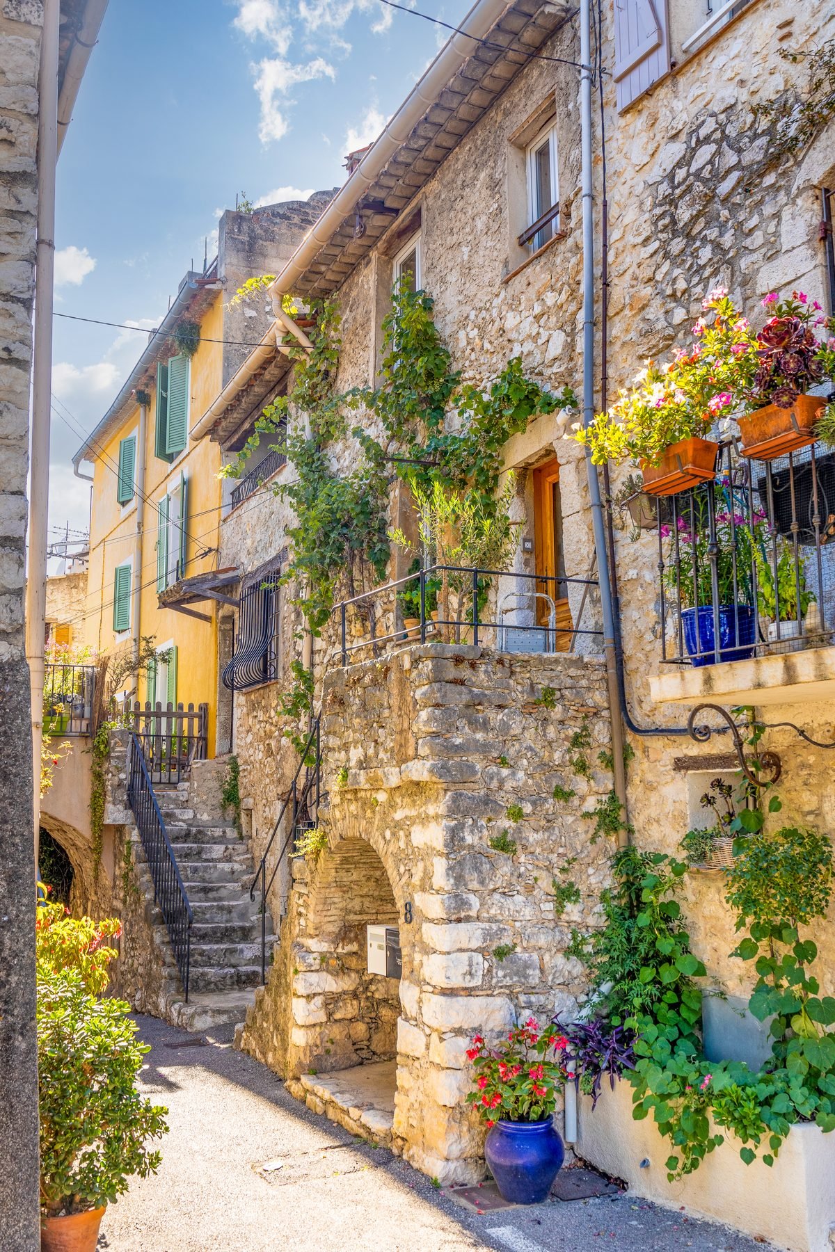 Escalier de pierre et balcons fleuris dans le vieux village