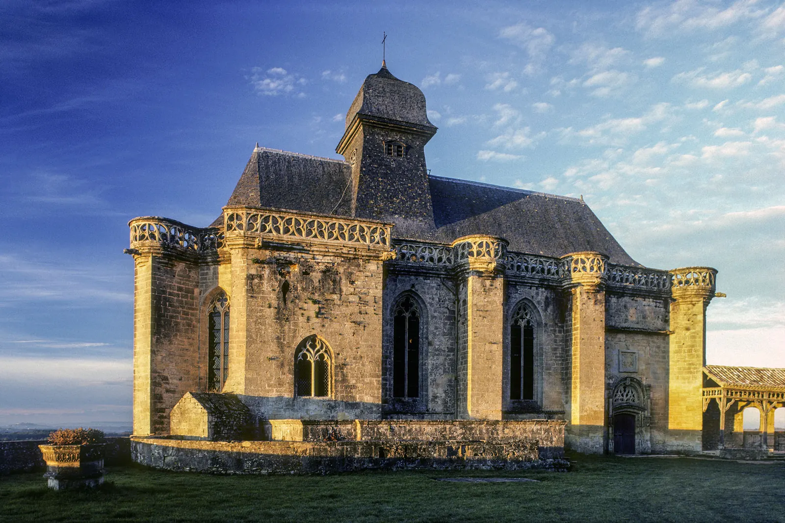 Chapelle gothique du château de Biron éclairée par le soleil levant